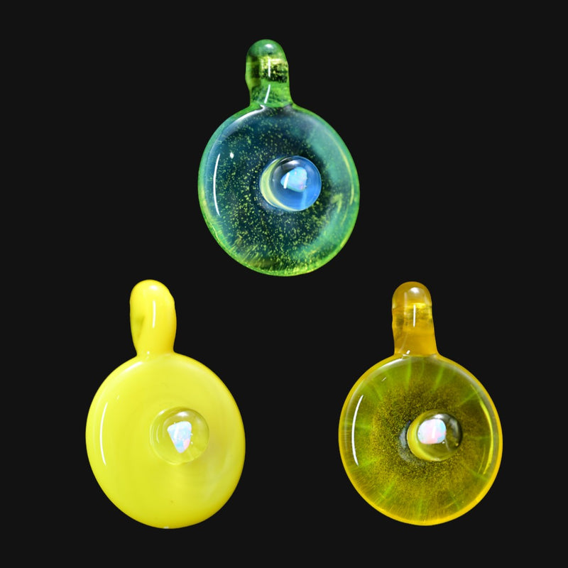 handmade glass disk pendants in yellow and green with central opal inlays on black background