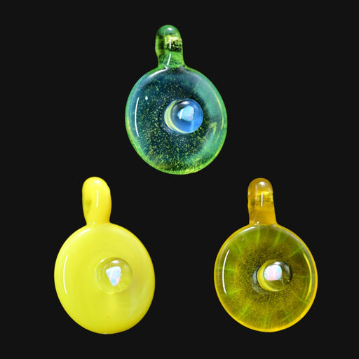 handmade glass disk pendants in yellow and green with central opal inlays on black background