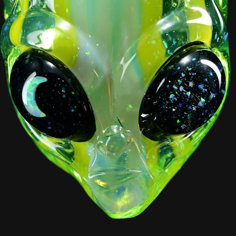 710 Pipes Smoke Shop Ghost Glass alien head pendant in green glass with a moon opal eye and galaxy-flecked black eyes.
