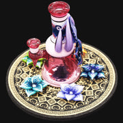 710 Pipes Smoke Shop pink glass rig with purple accents and 3-hole perc. Features worked neck, base, and opal flower detail.