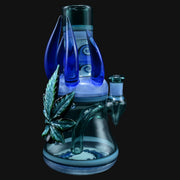710 Pipes Smoke Shop blue glass blossom rig with a green leaf accent and blue spikes.