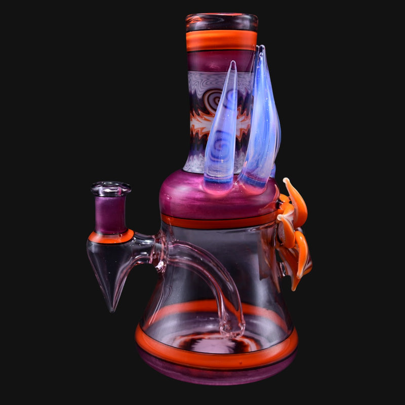 710 Pipes Smoke Shop Blossom Rig in pink and orange glass with blue accents and unique horn-like attachments.