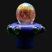 710 Pipes Smoke Shop Charisma Slurper Cap with a purple base, green glass accents, and a swirl-patterned dome top.