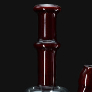 710 Pipes Smoke Shop dark red glass water pipe with a flared mouthpiece and a bulbous middle section.