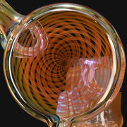 710 Pipes Smoke Shop fumed glass recycler featuring a detailed orange spiral disc pattern on a clear glass body
