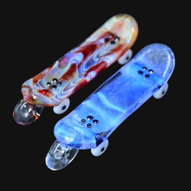 skateboard pendants in red swirl and blue nebula patterns with white wheels