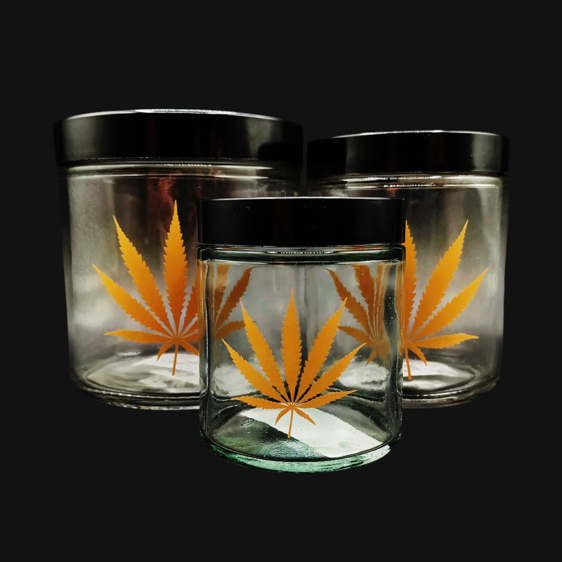 710 Pipes Smoke Shop clear glass stash jars with gold leaf cannabis leaf graphics and black screw top lids