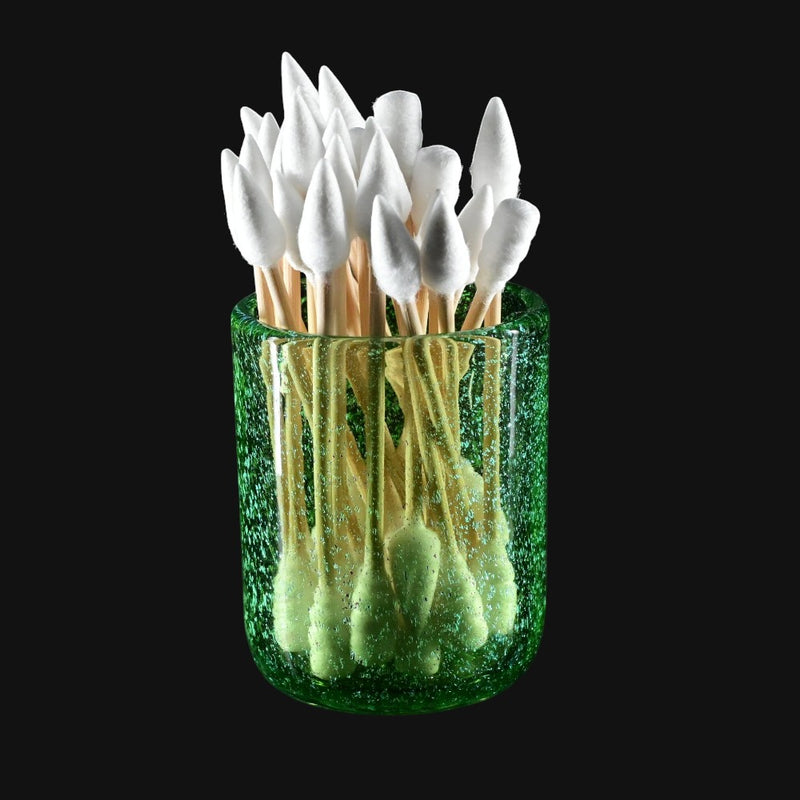 710 Pipes Smoke Shop transparent green glass jar with gold dichro and coral-style attachments holding white-tipped cotton swabs.