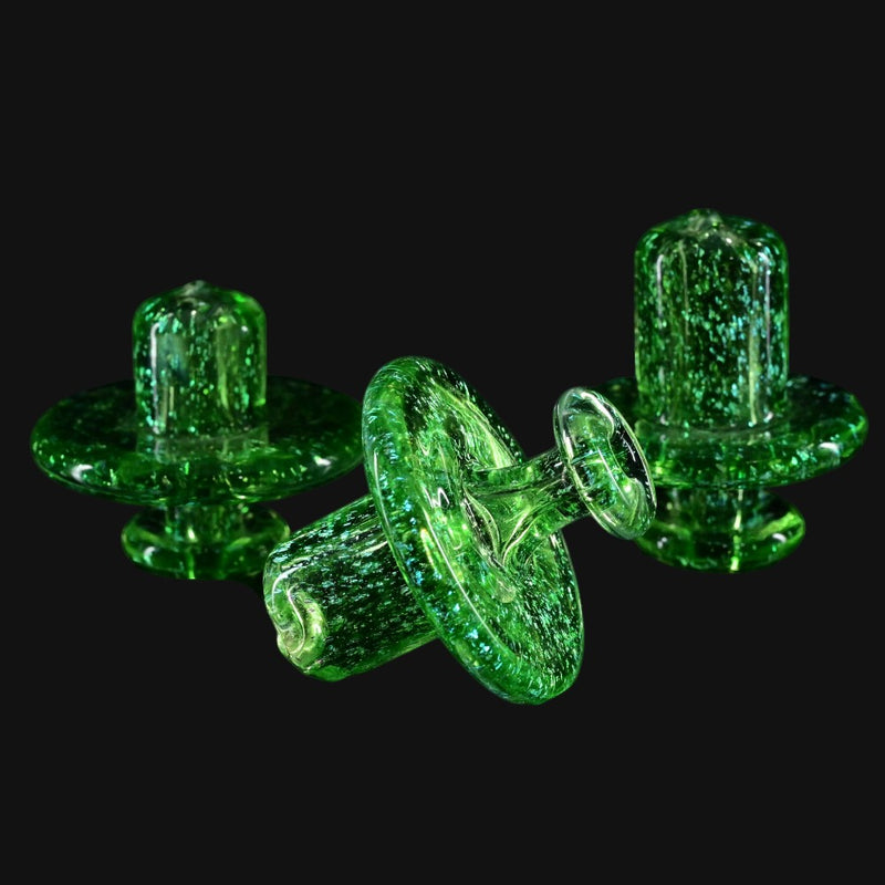 710 Pipes Smoke Shop transparent green glass spinner caps with gold dichro and coral-style attachments.