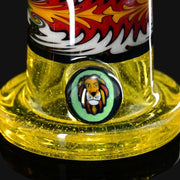 710 Pipes Smoke Shop Hedman Headies worked glass rig with yellow base and lion marble accent. Features flame design.