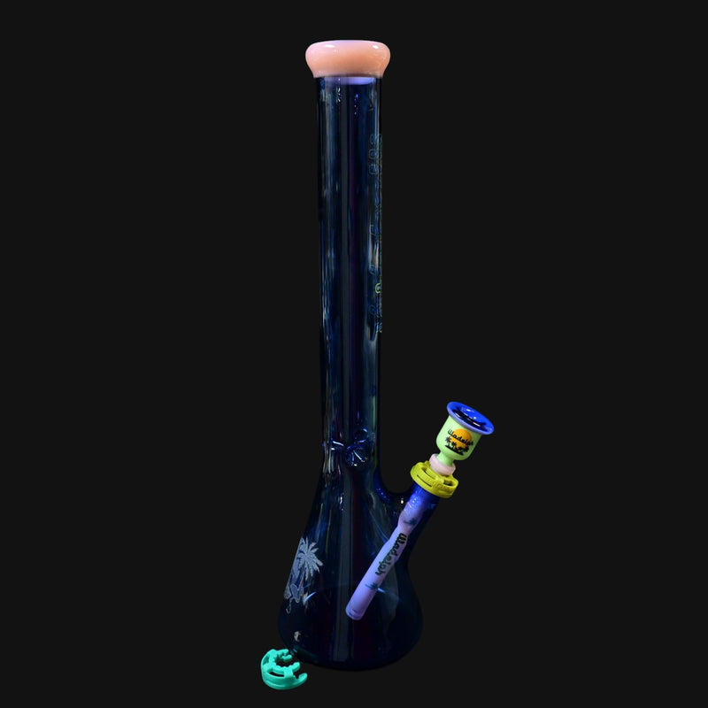 710 Pipes Smoke Shop Illadelph Premium Signature Beaker bong, deep blue glass with palm tree etching and pink mouthpiece.