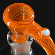 710 Pipes Smoke Shop Kadabra fully worked orange glass slide with a white opal horn accent.