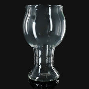 710 Pipes Smoke Shop Kadabra clear glass pint glass with a unique bulbous shape on a black background.