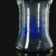 710 Pipes Smoke Shop Kadabra pint glass with a clear and deep blue gradient design on a black background.