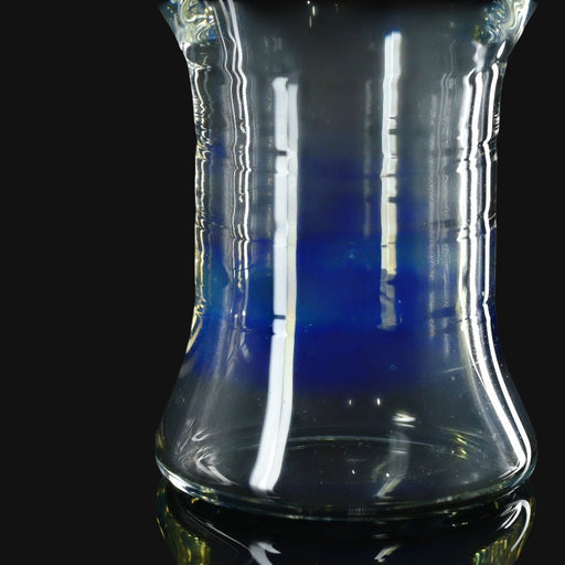 710 Pipes Smoke Shop Kadabra pint glass with a clear and deep blue gradient design on a black background.