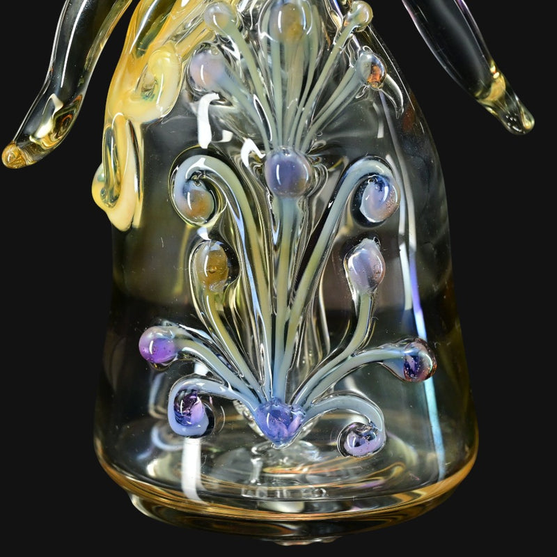 710 Pipes Smoke Shop Lyric Princess Rig in clear glass with purple and yellow accents, featuring intricate glasswork resembling a floral design.