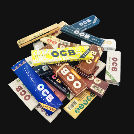 A collection of various OCB rolling papers from 710 Pipes Smoke Shop, including hemp, bamboo, and virgin varieties.