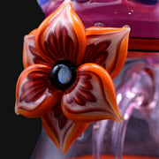 710 Pipes Smoke Shop orange and red glass flower rig with a black center and opal accent.