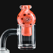 710 Pipes Smoke Shop Ras Glass orange crayon spinner bubble cap featuring a detailed skull millie design
