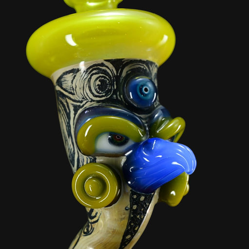 710 Pipes Smoke Shop Peyote Sight Eagle glass pipe with yellow, blue and green eyes, and blue nose.