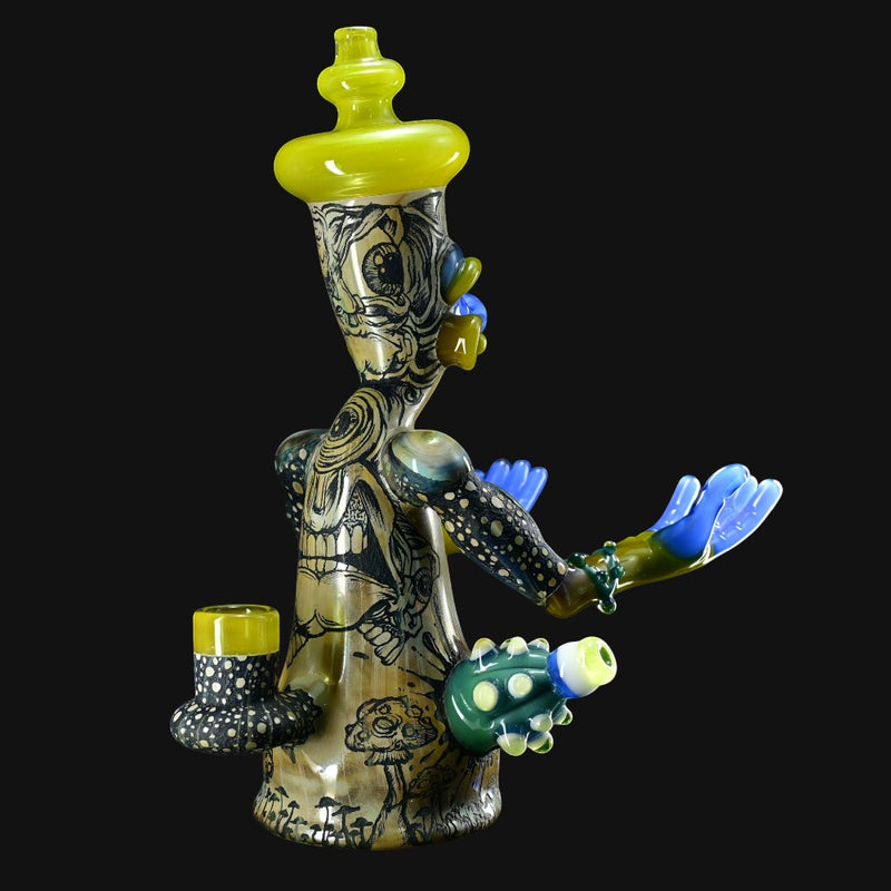 710 Pipes Smoke Shop Peyote Sight Eagle glass water pipe with yellow accents, blue hands, and mushroom designs.