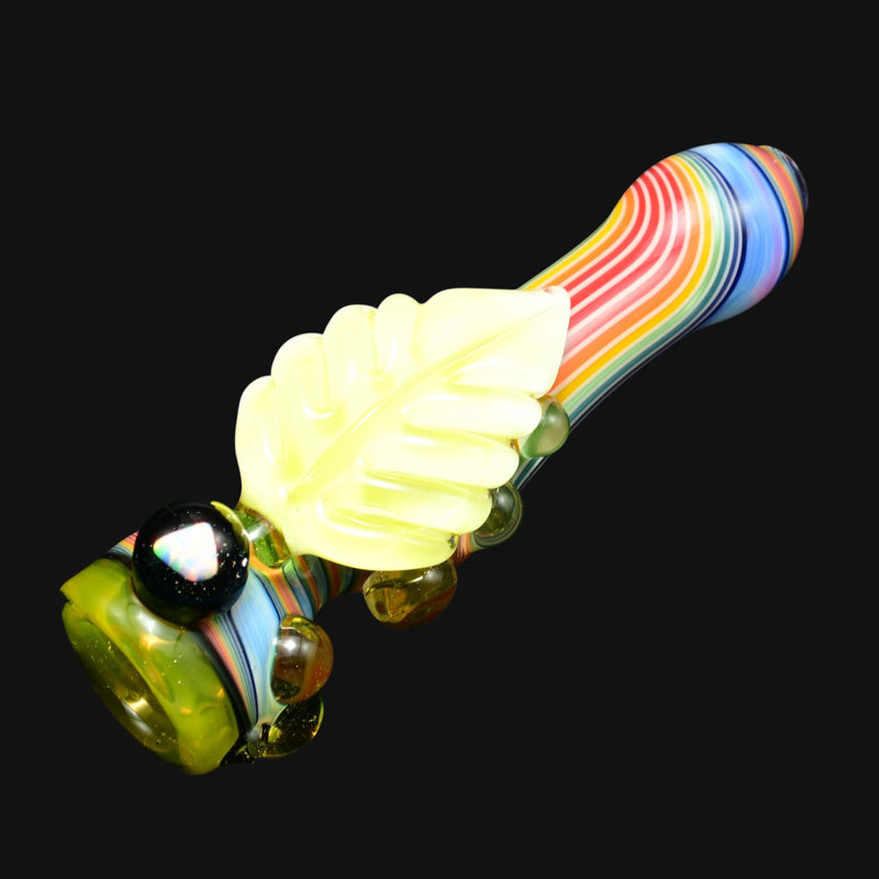 710 Pipes Smoke Shop glass pipe with rainbow stripes and a yellow leaf accent. Features a bowl with black and opal marbles.