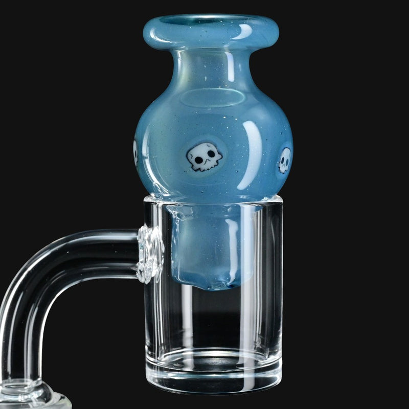 710 Pipes Smoke Shop Ras Glass blue bubble carb cap featuring white skull millie designs on a clear glass banger