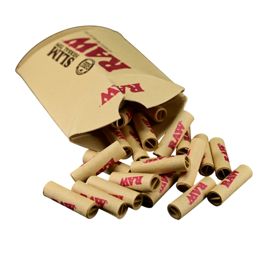 710 Pipes Smoke Shop RAW Slim herbal rolling tips spilling out of their tan paper packaging on a black background.