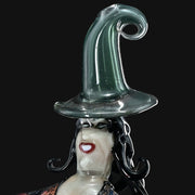 Rich Villa "Witches Get Stoned" glass recycler rig with a witch figure wearing a green hat. 710 Pipes Smoke Shop.