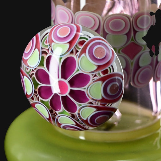 710 Pipes Smoke Shop RL. Dots Jammer glass dab tool with floral and concentric circle design in pink, purple, green, and white.