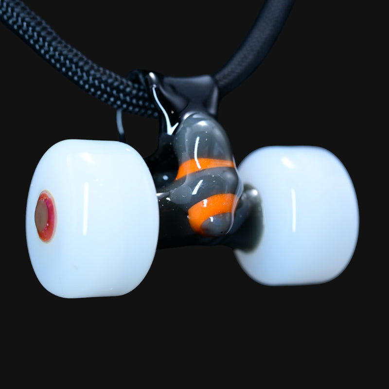 710 Pipes Smoke Shop Burning Bush glass pendant shaped like skateboard trucks with white wheels and orange accents