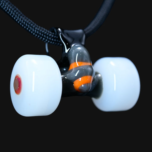 710 Pipes Smoke Shop Burning Bush glass pendant shaped like skateboard trucks with white wheels and orange accents