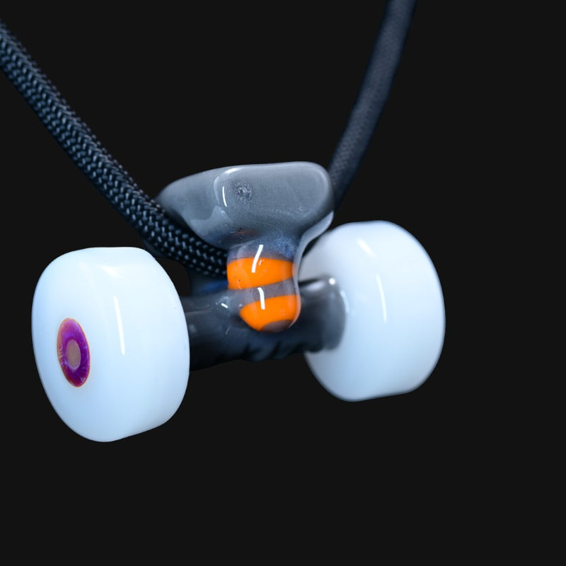 710 Pipes Smoke Shop Burning Bush glass pendant shaped like a skateboard truck with white wheels and orange accents.