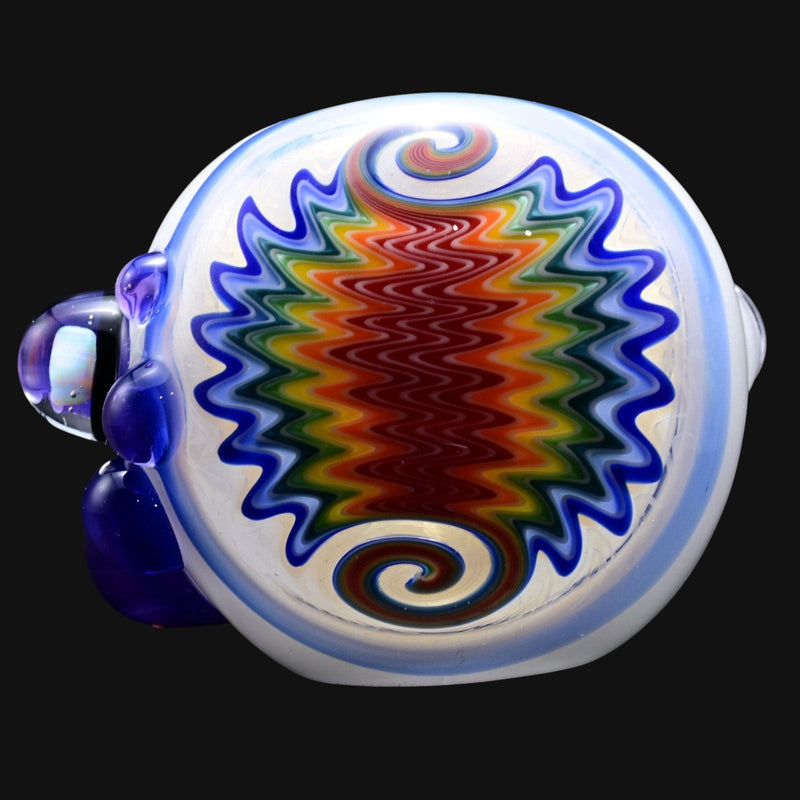 710 Pipes Smoke Shop Snow White glass spoon pipe with colorful wig wag design and blue accents.
