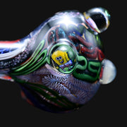 710 Pipes Smoke Shop glass spoon pipe featuring a Spongebob dichroic marble, white banding, and intricate glass art.