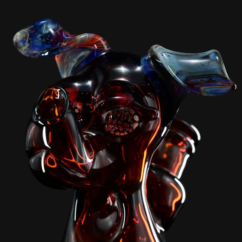 710 Pipes Smoke Shop T_Tree Glass Ruffer jammer featuring a dark amber glass dog design with blue iridescent ears.