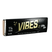 710 Pipes Smoke Shop Vibes 1 1/4 size ultra thin rolling papers and tips in black packaging with gold lettering.