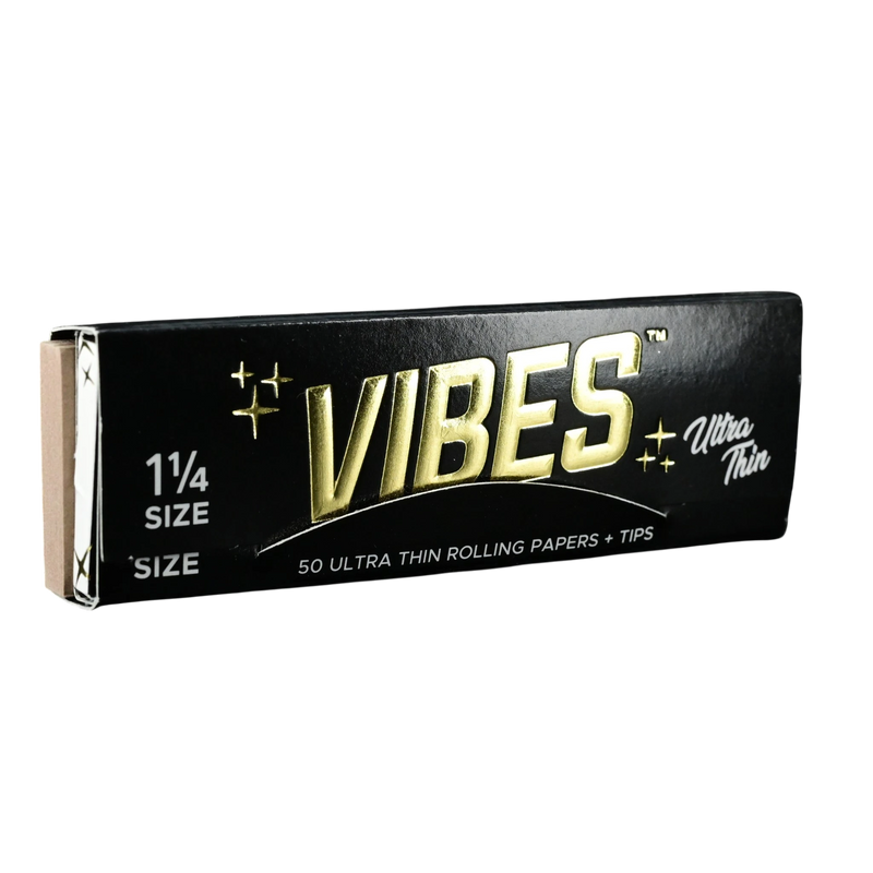 710 Pipes Smoke Shop Vibes 1 1/4 size ultra thin rolling papers and tips in black packaging with gold lettering.