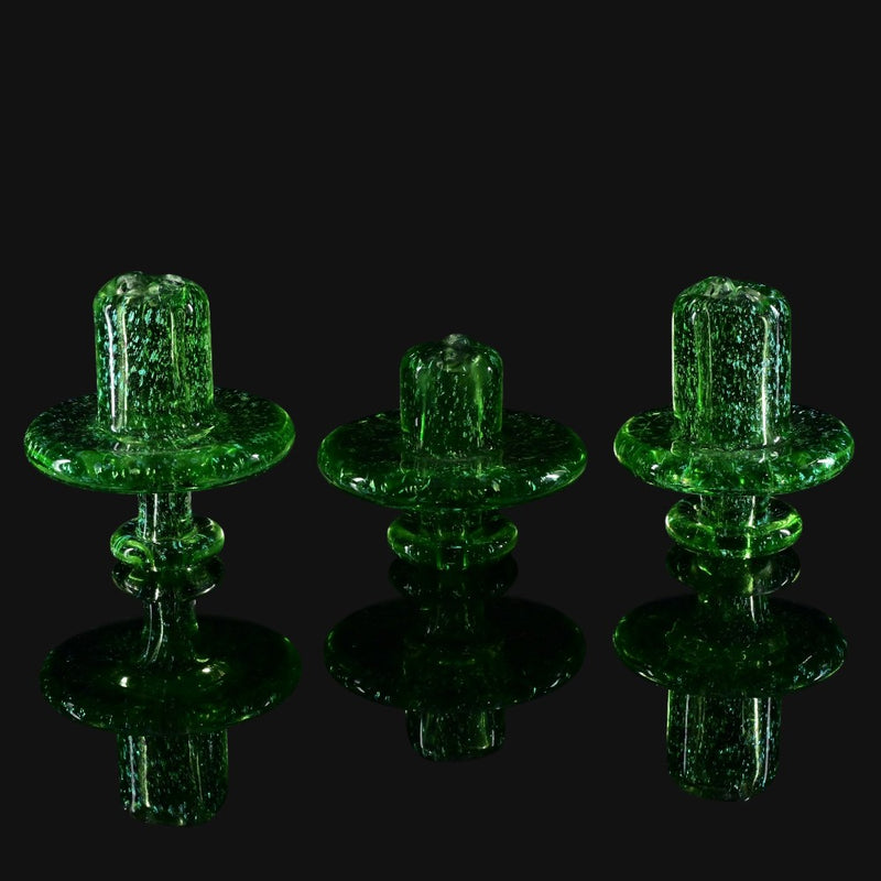 710 Pipes Smoke Shop W.C. Stearns transparent green glass spinner caps with gold dichro and coral-style attachments.