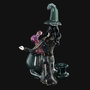 710 Pipes Smoke Shop Rich Villa "Witches Get Stoned" glass recycler rig with witch figure, cauldron, and pink orb.
