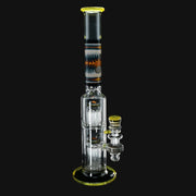 710 Pipes Smoke Shop yellow glass bong with orange and blue wigwag accents, two tree percs, and 14mm joint.