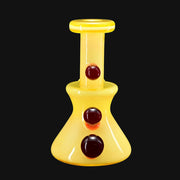 710 Pipes Smoke Shop yellow glass micro dab rig with 10mm joint and three dark red marbles.