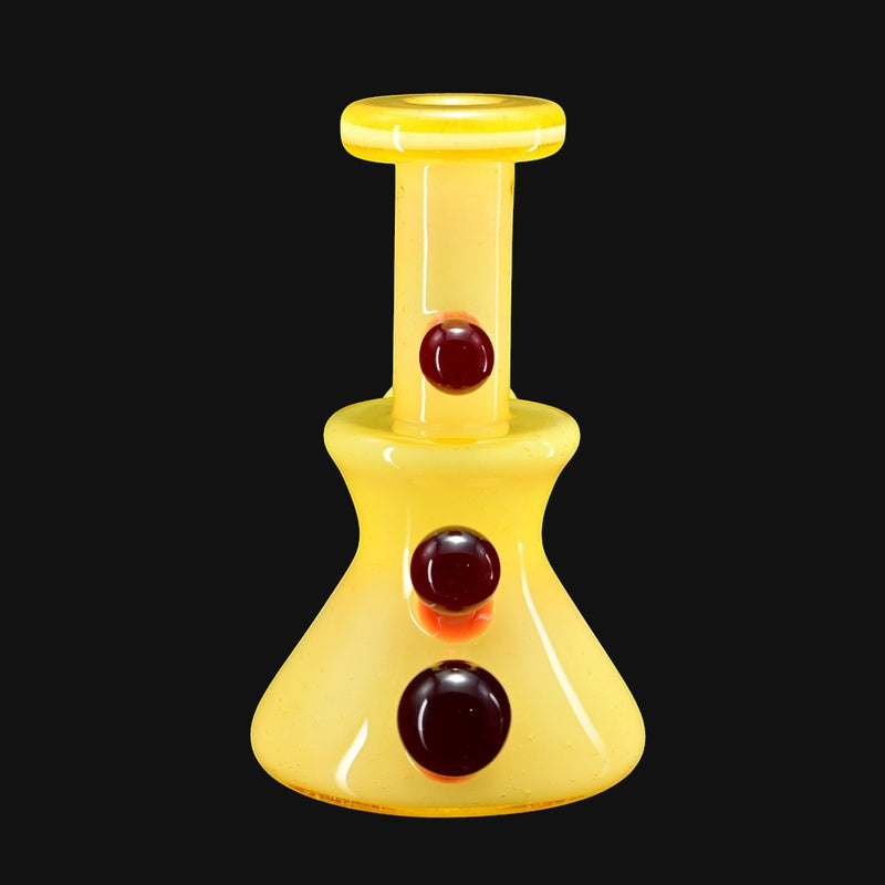 710 Pipes Smoke Shop yellow glass micro dab rig with 10mm joint and three dark red marbles.