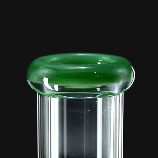 710 Pipes Smoke Shop close up view of Color Lip Beaker 50 water pipe featuring a clear glass neck with a vibrant green glass rim.