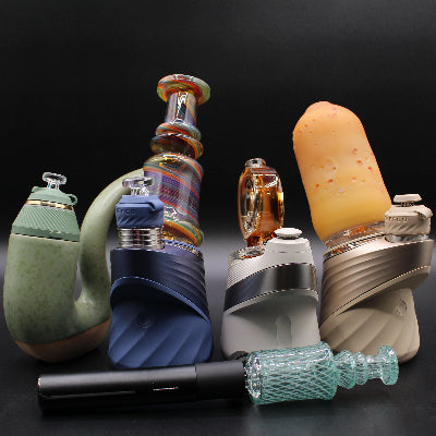 Collection of various Puffco vaping devices on a dark background