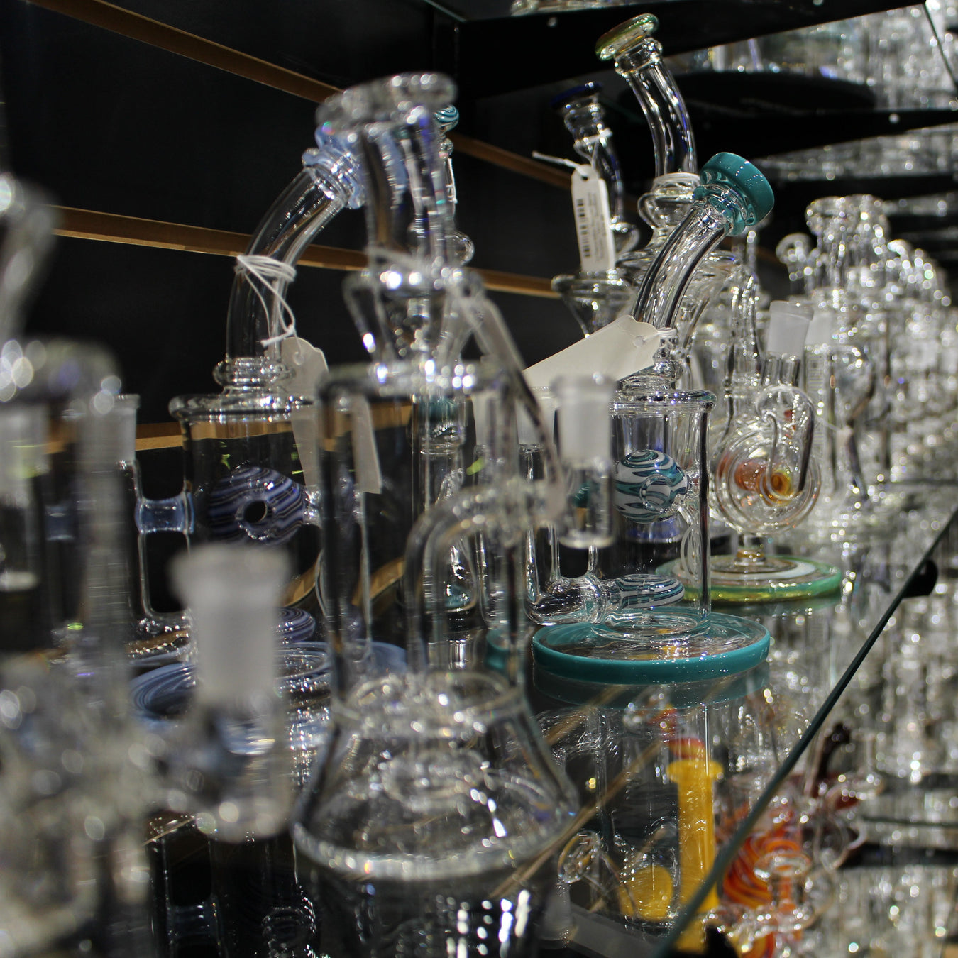 Collection of American glass smoking products on a shelf in a smoke shop.