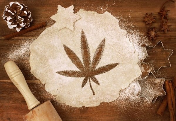 Cannabis leaf shape cut from rolled dough with cookie cutters