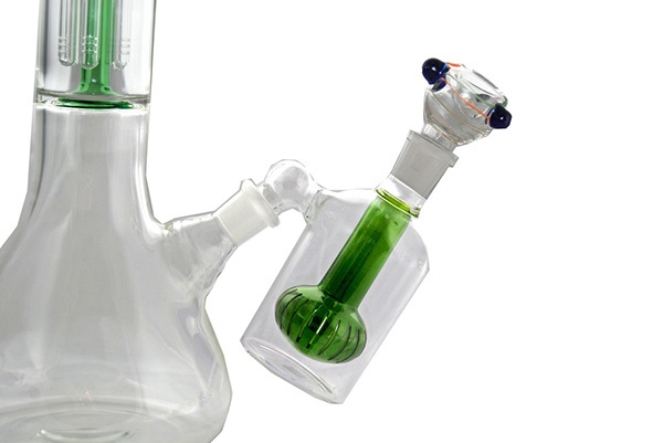 Side view of white and green bong's base with removable ask catcher