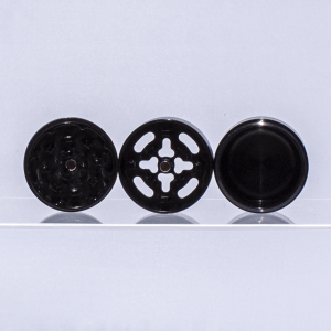 Three pieces of black Santa Cruz aluminum grinder