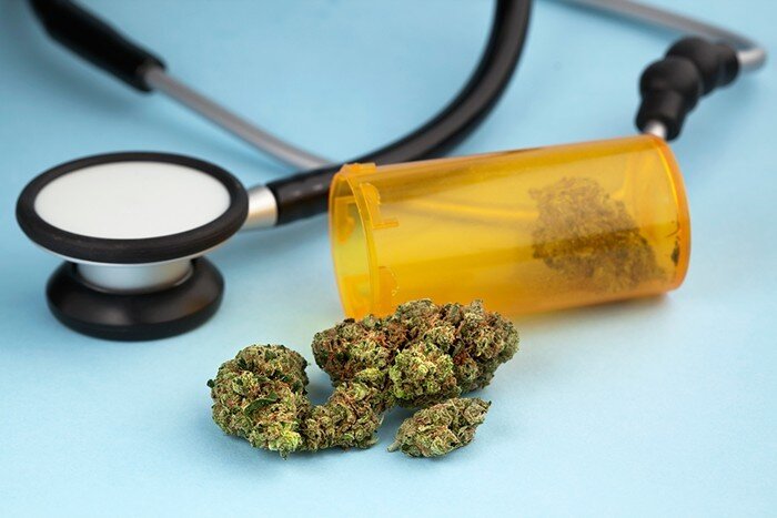 Stethoscope and Pill Bottle with Cannabis Nuggets Inside